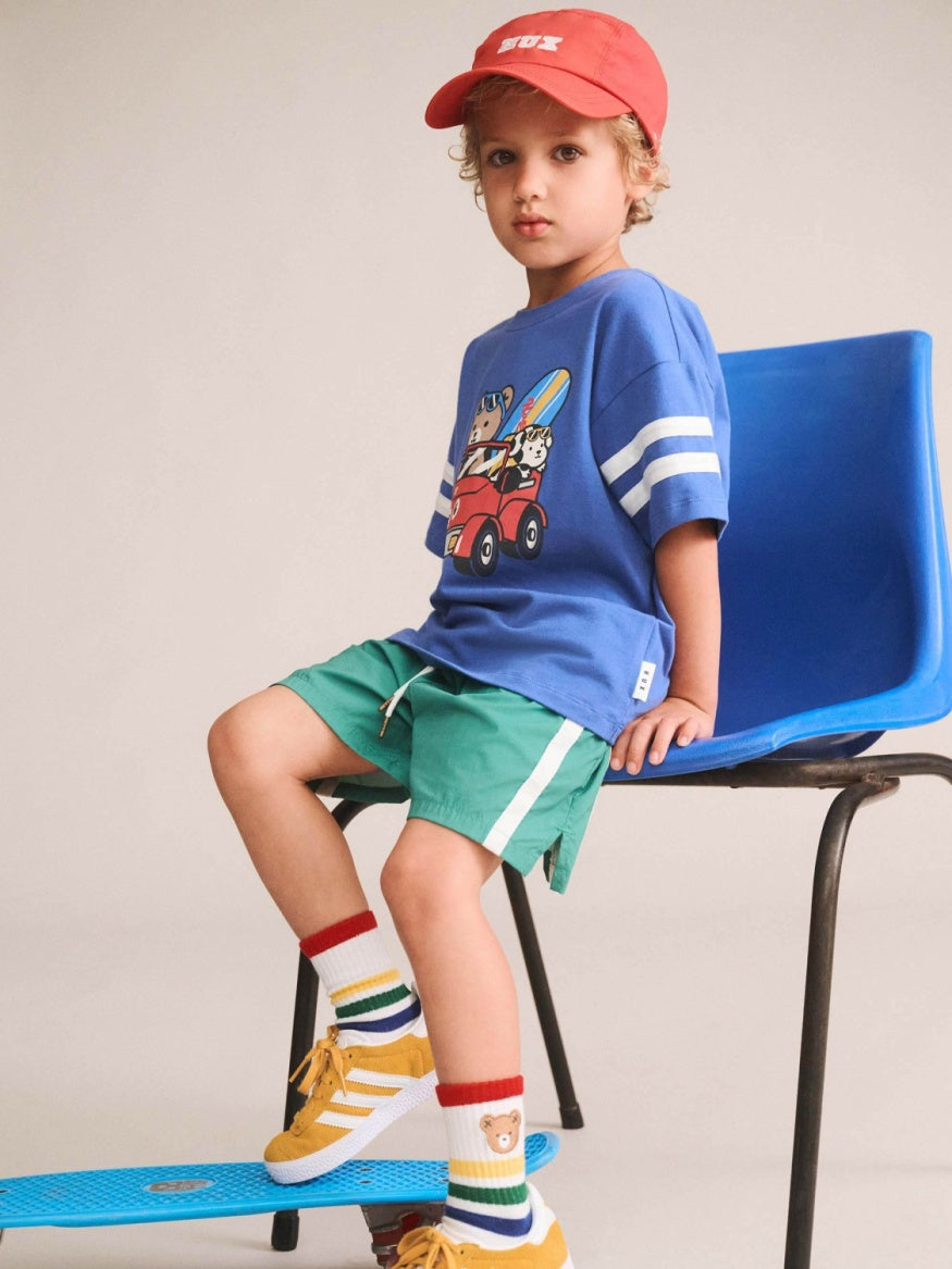 Boy wearing Huxbaby Beach Buggy Sporty Slouchy Tee featuring a relaxed oversized fit, soft fabric, and sporty beach-inspired design for kids.