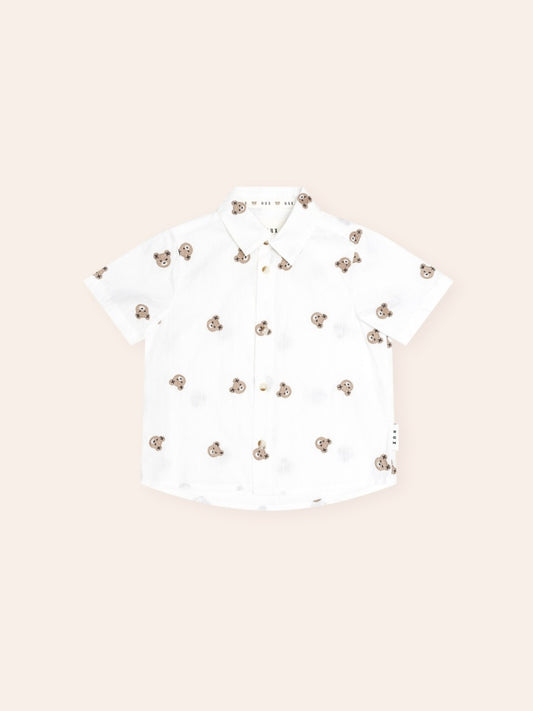 Huxbaby All Over Hux Emb Short Sleeve Shirt featuring an all-over Hux embroidery pattern, classic button-up design, short sleeves, and lightweight fabric for smart casual kids' wear.