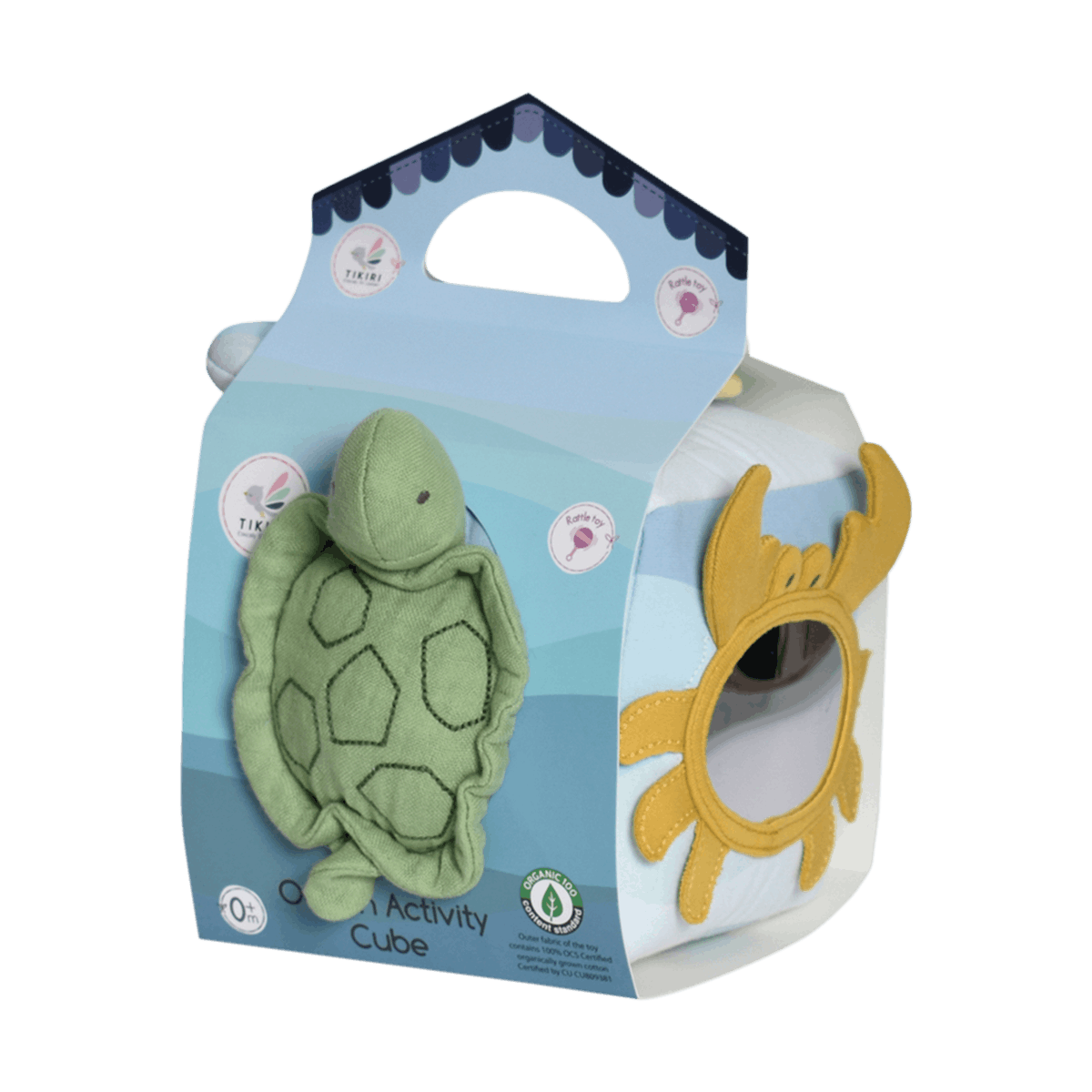 A baby sensory activity cube toy with a green plush sea turtle on the front and a yellow plush sun on the side, packaged in a light blue cardboard box with a handle against a black background.