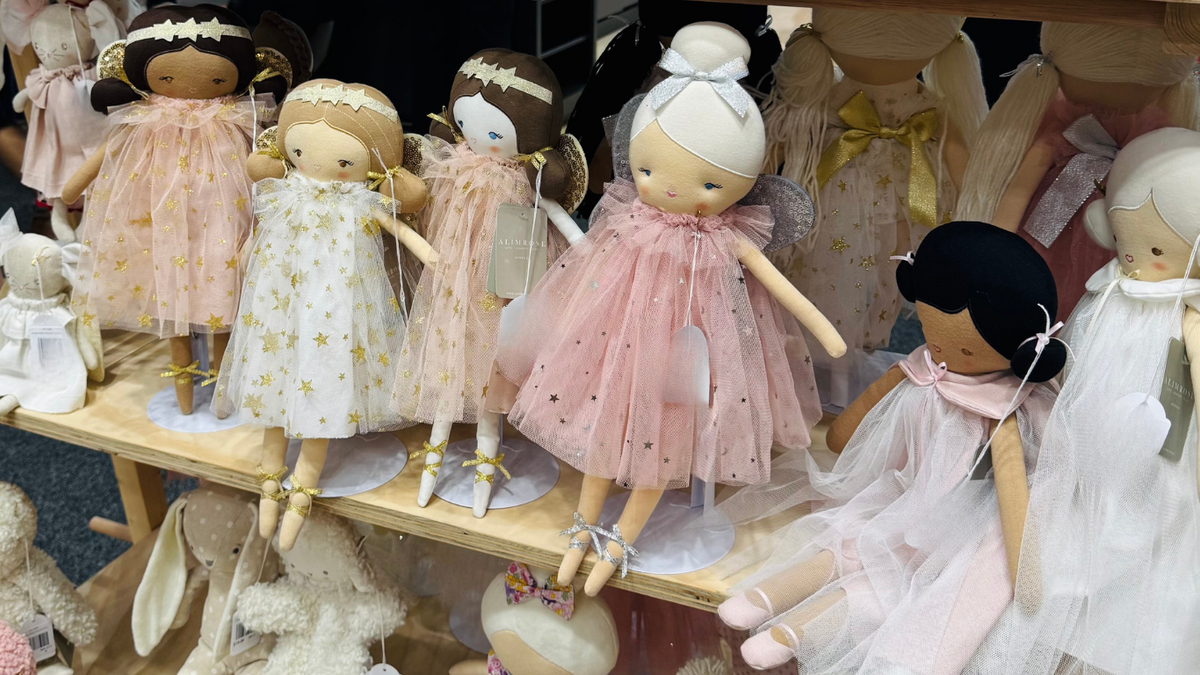 Handmade Alimrose fairy dolls in tulle dresses lined up on a shelf in the Enchanted Years shop