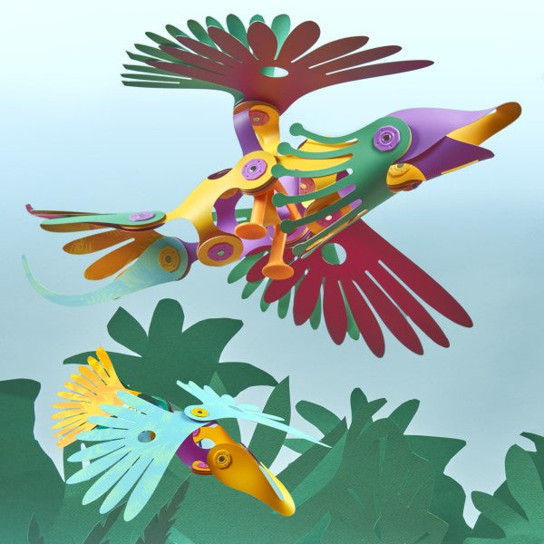 Play ideas for Clixo Magnetic Toy 22-piece Tropical Birds Pack, featuring colourful flexible magnetic building pieces in tropical-inspired shades of green, blue, yellow, orange, and pink. The set includes geometric shapes and connectors that snap together to create bird-themed and other imaginative 2D and 3D creations, displayed neatly on a white background.