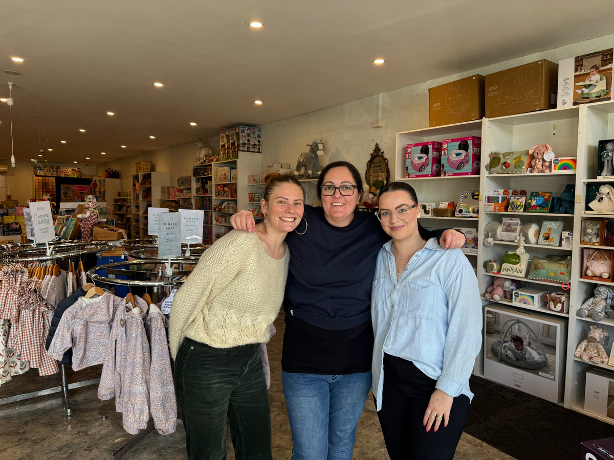The Enchanted Years team together inside the Williamstown shop, surrounded by toys and children's clothing