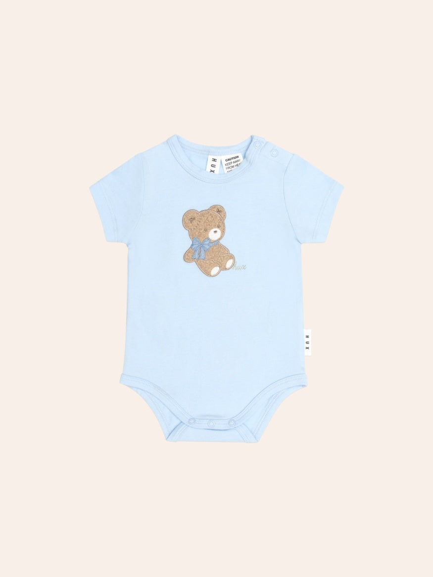 Huxbaby Bear Bow Hux Short Sleeve Bodysuit featuring a cute Huxbear bow detail, soft fabric and comfortable fit for babies and toddlers.