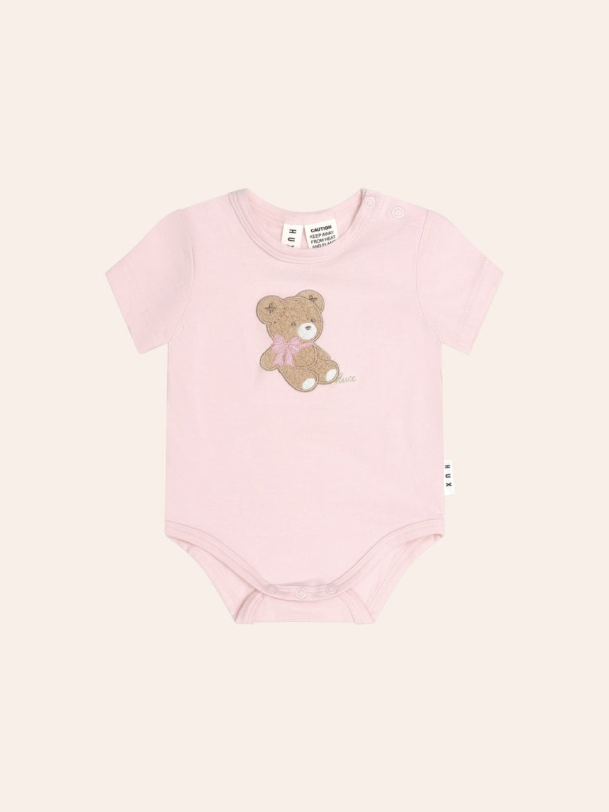 Huxbaby Bow Huxette Short Sleeve Bodysuit in soft baby fabric with cute bow detail, designed for comfortable everyday wear.