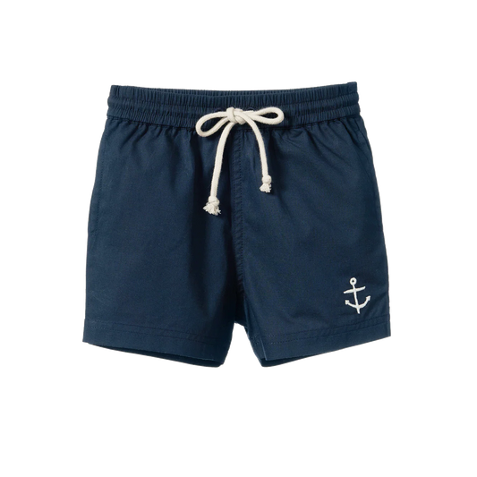 Nature Baby James Shorts in navy, featuring classic children's shorts made from soft woven fabric. The shorts have an elastic waistband with an adjustable drawstring, side pockets, a relaxed fit, and a simple knee-length design in a solid navy colour.